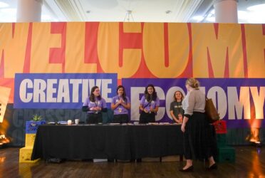 four women welcome a woman into the creative summit