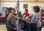 black women at a business bazaar discussing the business