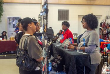 black women at a business bazaar discussing the business